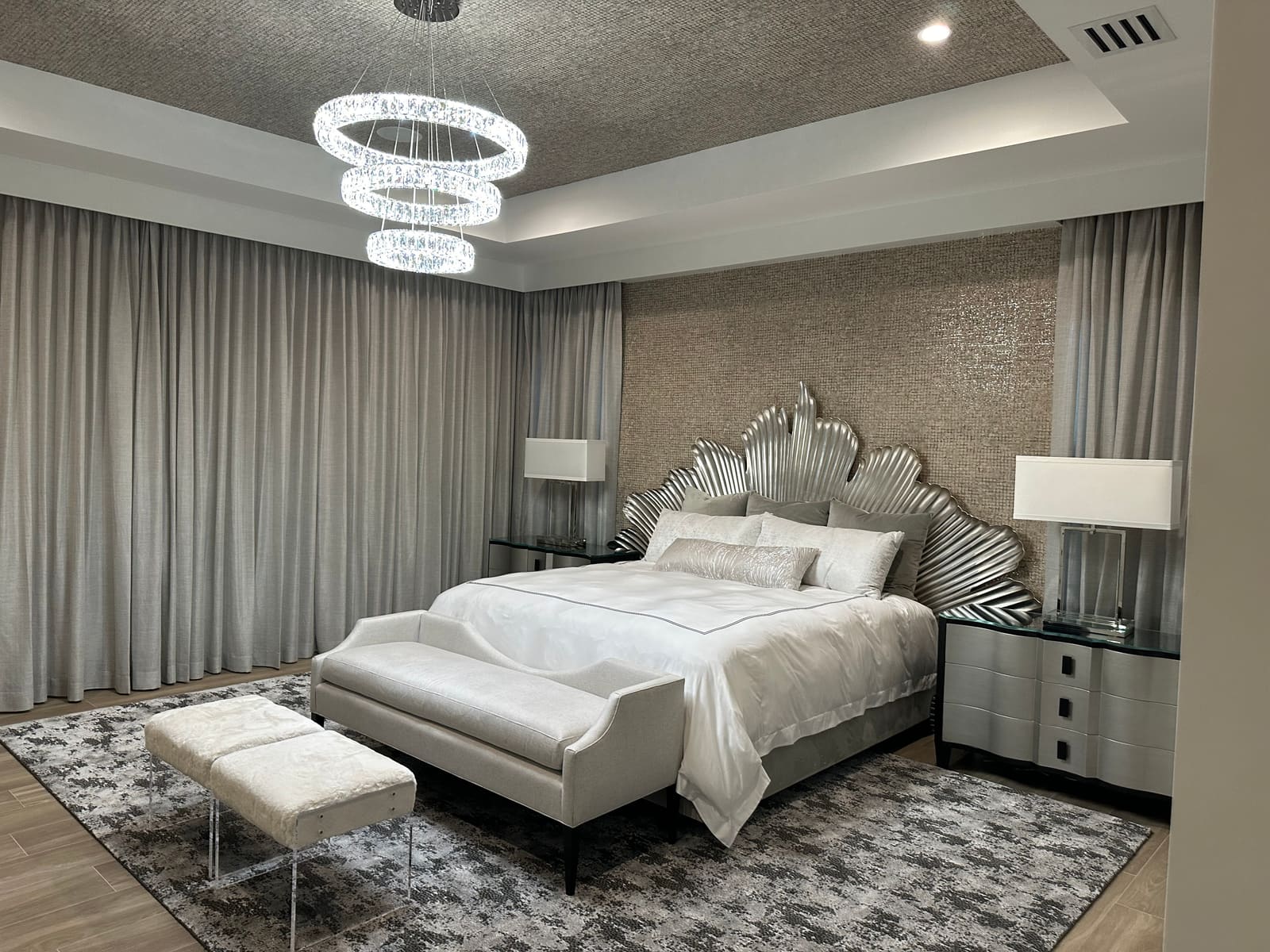 Luxury primary bedroom with tiered chandelier