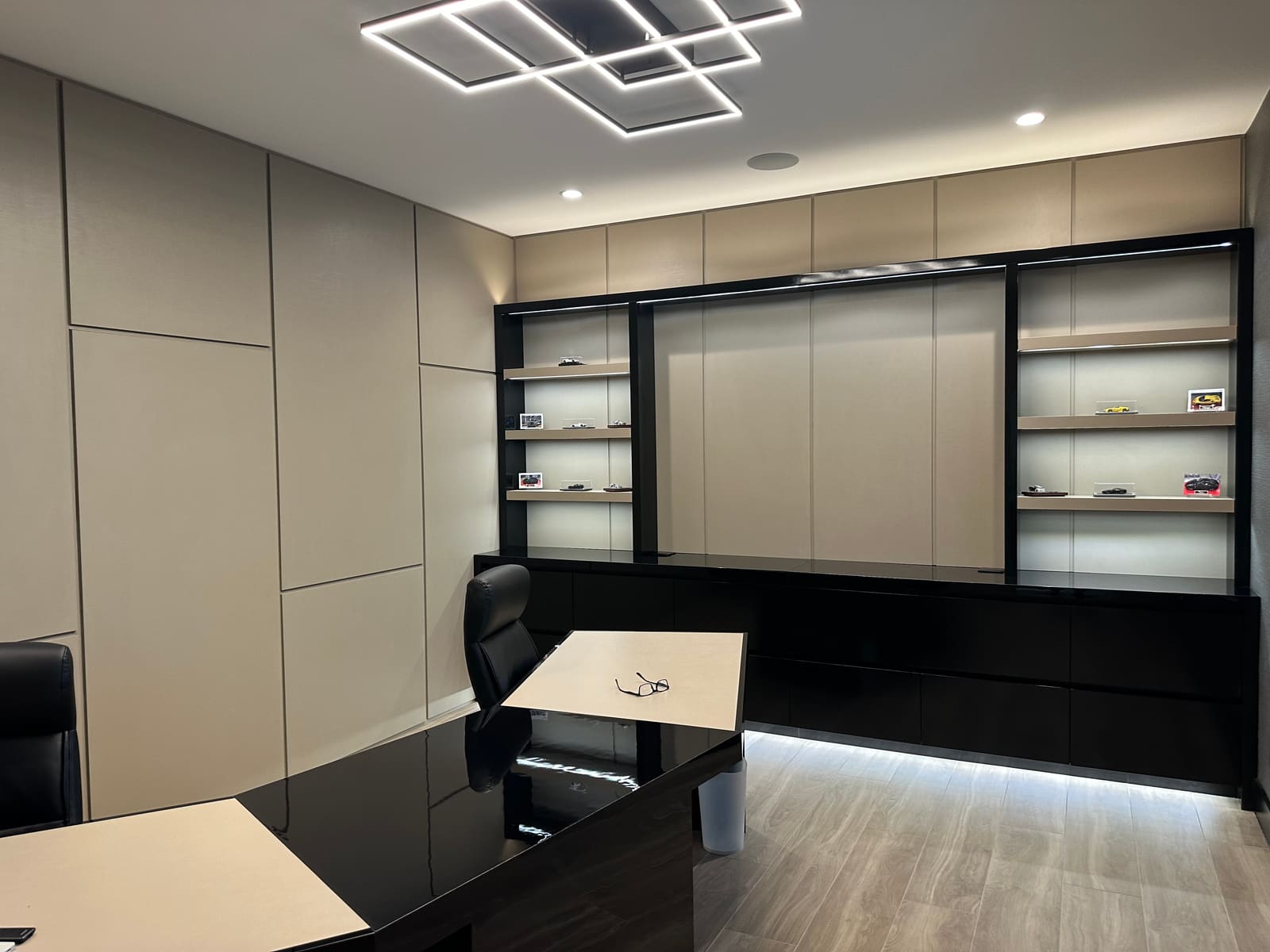 Home office with backlit built-in shelving